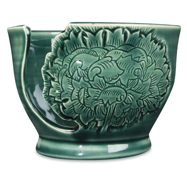 Glossy ceramic plate glazed with Amaco Celadon high-fire liquid glaze showcasing vibrant, transparent colors and detailed texture.